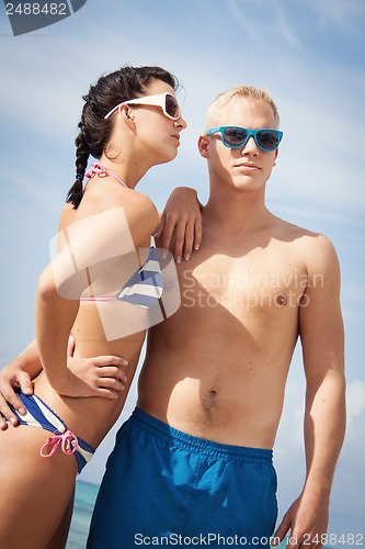 Image of attractive young couple in swimwear and sunglasses