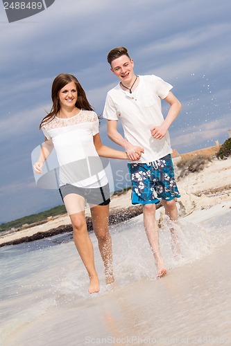 Image of happy young couple on the beach in summer holiday love