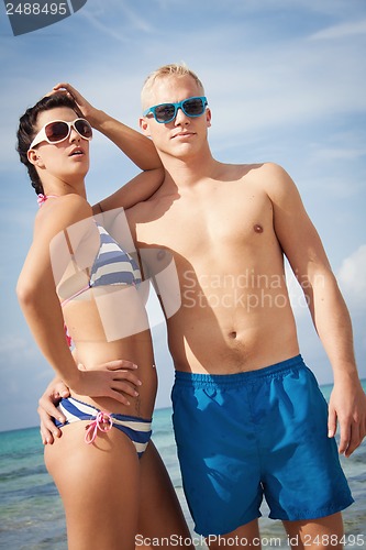 Image of attractive young couple in swimwear and sunglasses