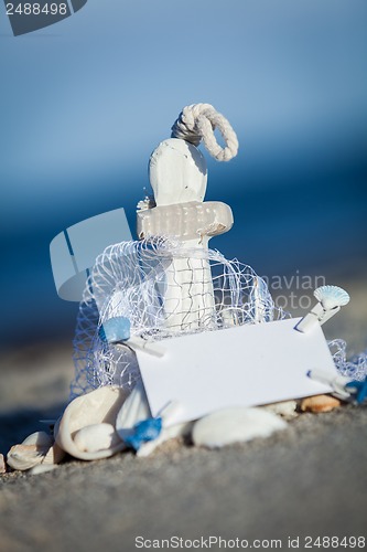 Image of sailing boat and seashell in sand decoration closeup