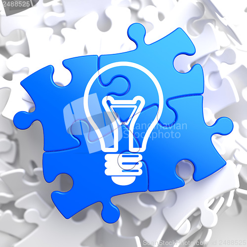 Image of Light Bulb Icon on Blue Puzzle.