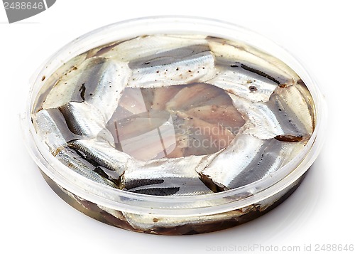 Image of salted anchovies in plastic container