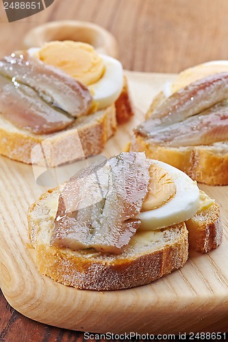 Image of bread with egg and anchovies