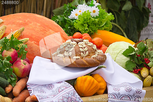 Image of Beautiful cake on a white towel, vegetables, fruits.