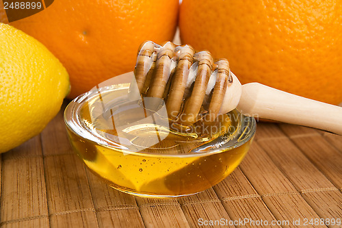 Image of fresh honey with lemon and orange fruits