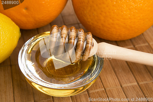 Image of fresh honey with lemon and orange fruits