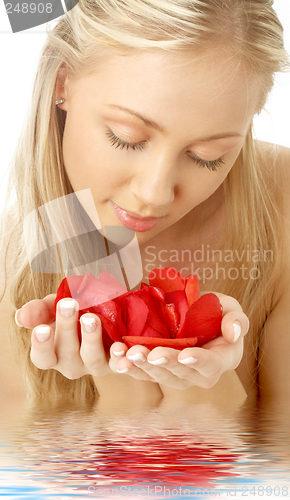 Image of lovely blond in water with red rose petals