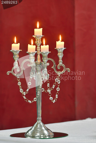 Image of Silver classic candlestick isolated on red