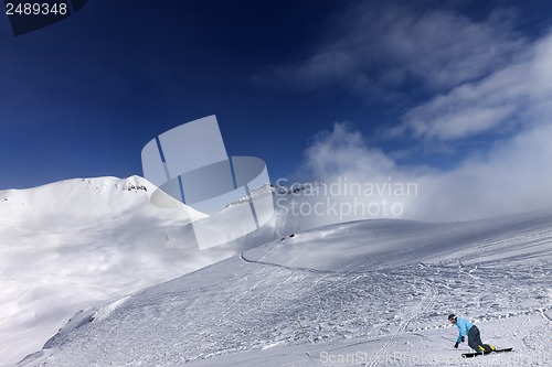Image of Snowboarder on ski slope at nice day