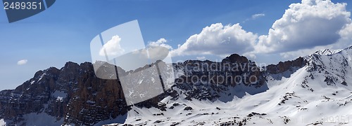 Image of Panorama of snowy mountains in spring sunny day