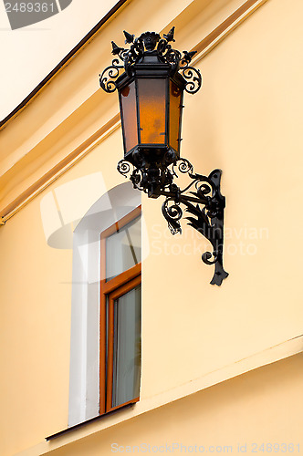 Image of Old lamp with windows on wall