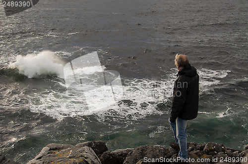 Image of Man watching the ocean waves