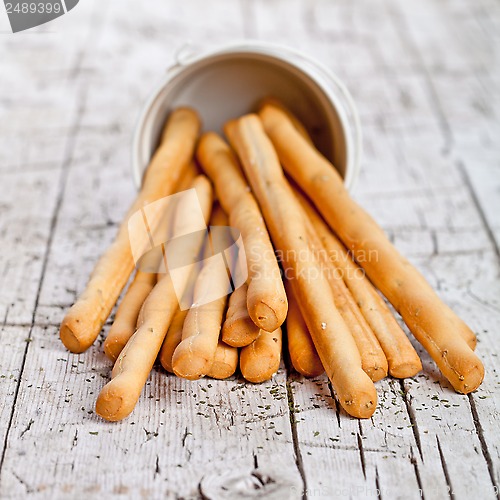 Image of cup with bread sticks grissini