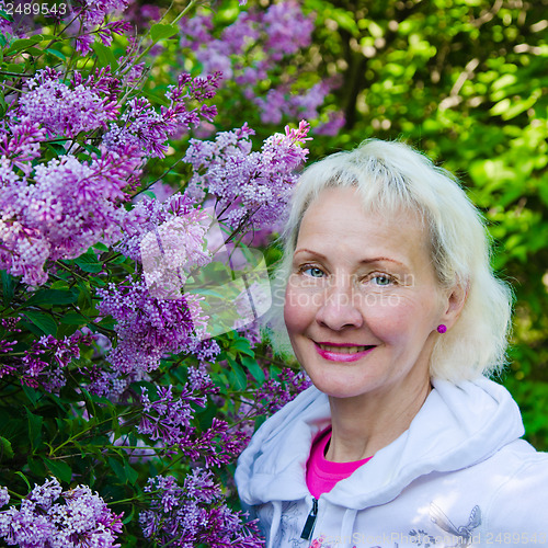 Image of Portrait of a woman from a Bush blooming lilac 