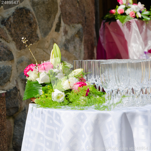 Image of Bouquet of flowers and wine glasses for a wedding table 