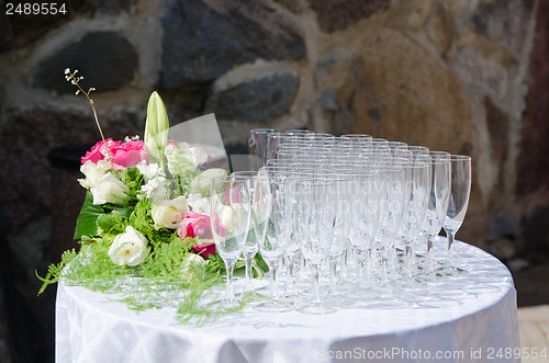 Image of Bouquet of flowers and wine glasses for a wedding table 