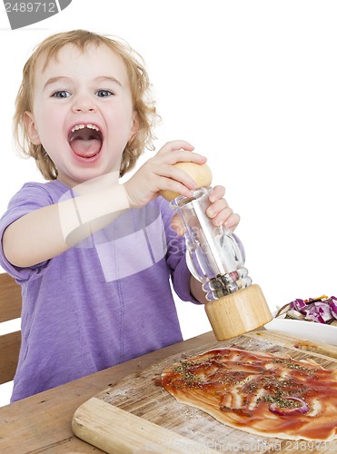 Image of happy child making pizza