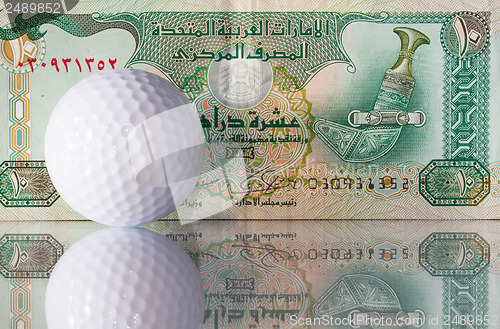 Image of Dirhams and golf ball