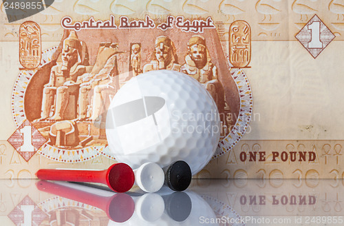 Image of Egyptian money and golf equipments