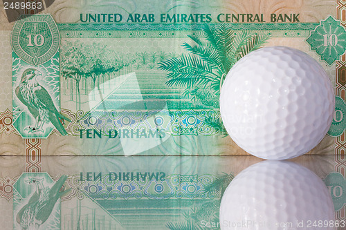 Image of Dirhams and golf ball