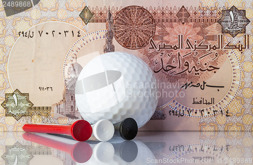 Image of Egyptian money and golf equipments