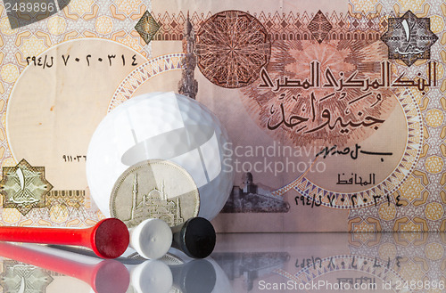 Image of Egyptian money and golf equipments