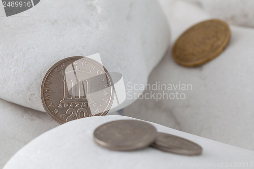 Image of Greek drachma coins on a white stones