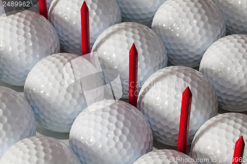 Image of Golf balls and wooden tees in open box