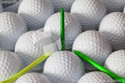 Image of Golf balls and wooden tees in open box