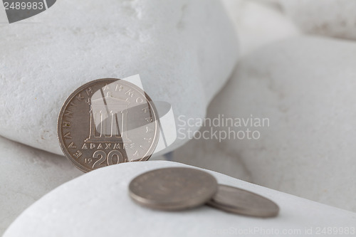 Image of Greek drachma coins on a white stones