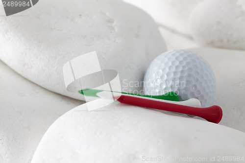 Image of Golf ball and tees between white stones