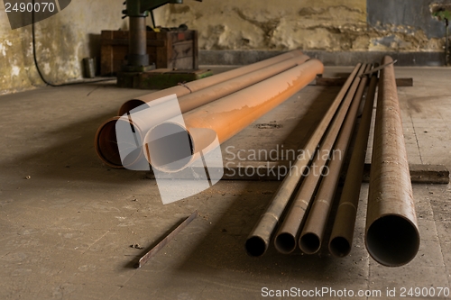 Image of Piled Old, rusty, dirty pipes