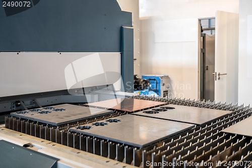 Image of Machine cutting steel in a factory