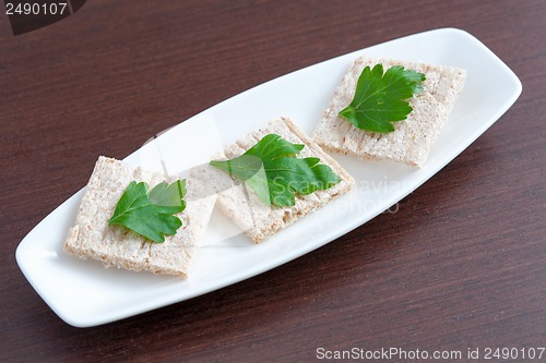 Image of Diet bread with parsley on a plate