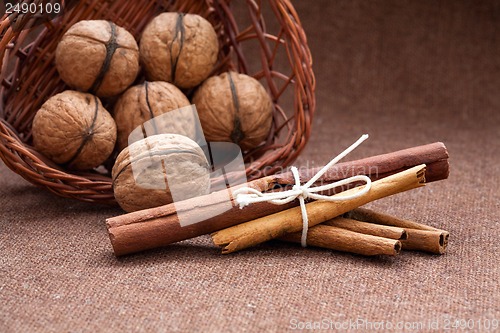 Image of Walnuts in a wicker basket and cinnamon