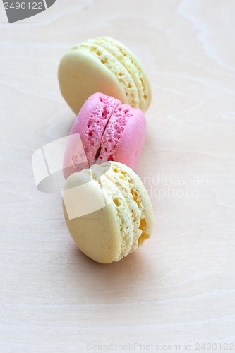 Image of Colorful macaroons on wooden background