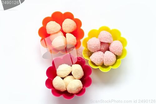 Image of sweet jelly candies in cup cake cases on white