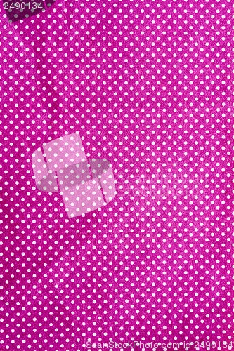 Image of wrinkled purple cloth with a white dot