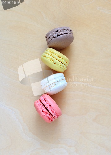 Image of Colorful macaroons on wooden background