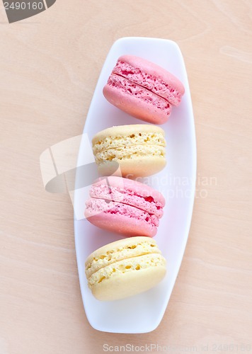 Image of pink and yellow macaron on a plate
