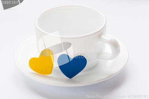 Image of empty cup and saucer with hearts