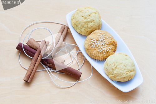 Image of biscuits on a plate and cinnamon sticks