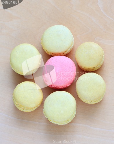 Image of Colorful macaroons on wooden background