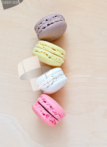 Image of Colorful macaroons on wooden background