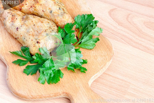 Image of Fried chicken legs with parsley on the board