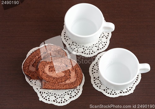 Image of chocolate roll on napkins and cup