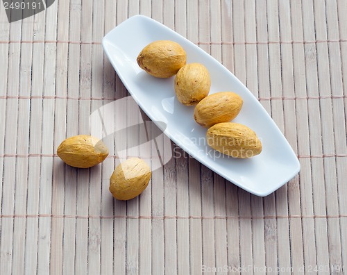 Image of dish of nuts on a bamboo napkin