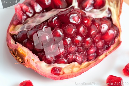 Image of The cut pomegranate and grains on a plate