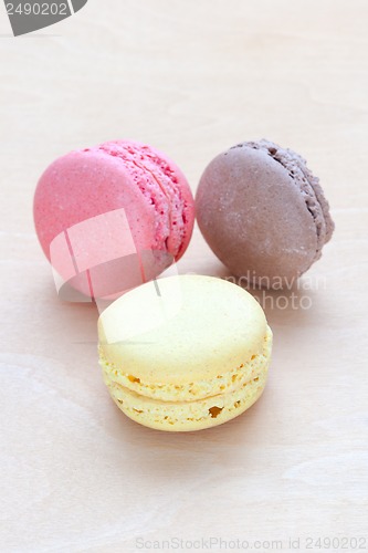 Image of colored macaron on wooden background