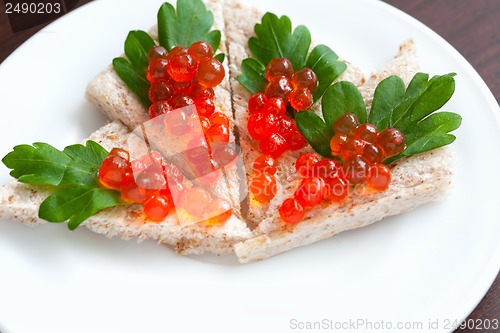 Image of Tartlets with caviar and parsley on a plate